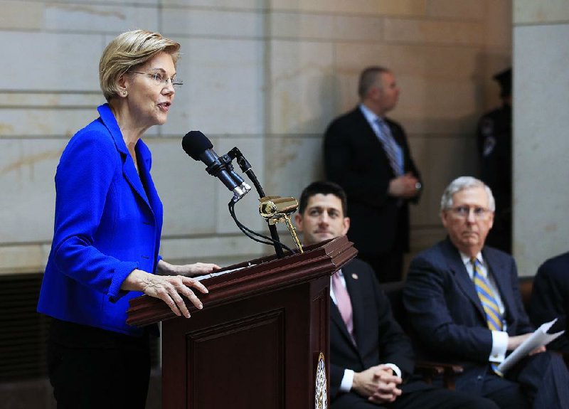 FILE — Sen. Elizabeth Warren, D-Mass., from left, speaks, while House Speaker Paul Ryan of Wis., and Senate Majority Leader Mitch McConnell of Ky., listen during a ceremony in the U.S. Capitol's Emancipation Hall in Washington, Wednesday, Nov. 8, 2017.