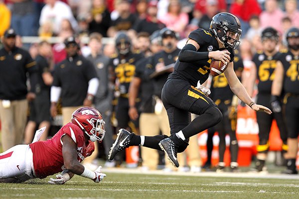 Missouri quarterback Drew Lock is tackled by Arkansas linebacker De'Jon Harris during a game Friday, Nov. 24, 2017, in Fayetteville. 