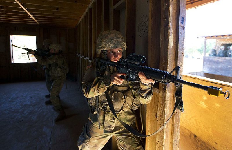 A female U.S. Army recruit practices building clearing tactics with male recruits at Fort Benning, Ga., in October. The Army’s introduction of women into the infantry has moved steadily but cautiously this year.