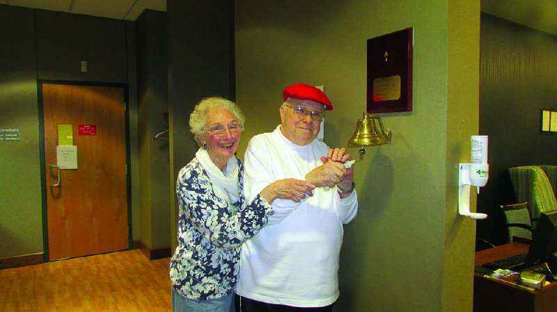 Jan and C. Dennis Schick enjoy a bit of ceremony July 21, ringing a bell at Arkansas Prostate Cancer Center in Little Rock after his fi nal radiation treatment for prostate cancer.