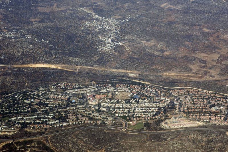 In this Sept. 20 2010 aerial file photo, taken through the window of an airplane shows the West Bank Jewish settlement of Ariel Weeks ahead of the expected completion of a U.N. database of companies that operate in Israel's West Bank settlements, Israel and the Trump Administration are working feverishly to prevent its publication. Dozens of major Israeli companies, and dozens of multinationals that do business in Israel, are expected to appear on the list. 