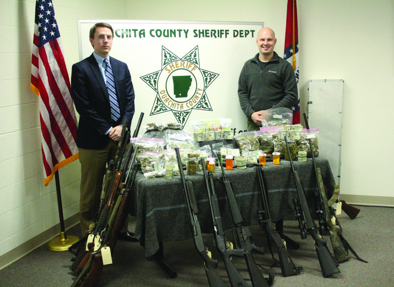 Arrest made over drugs, counterfeit money 
13th Judicial District Prosecuting Attorney John Thomas Shepherd, left, stands with Ouachita County Sheriff Department Deputy Ryan Coleman, right, during a press conference regarding a large drug bust in the area. See related article