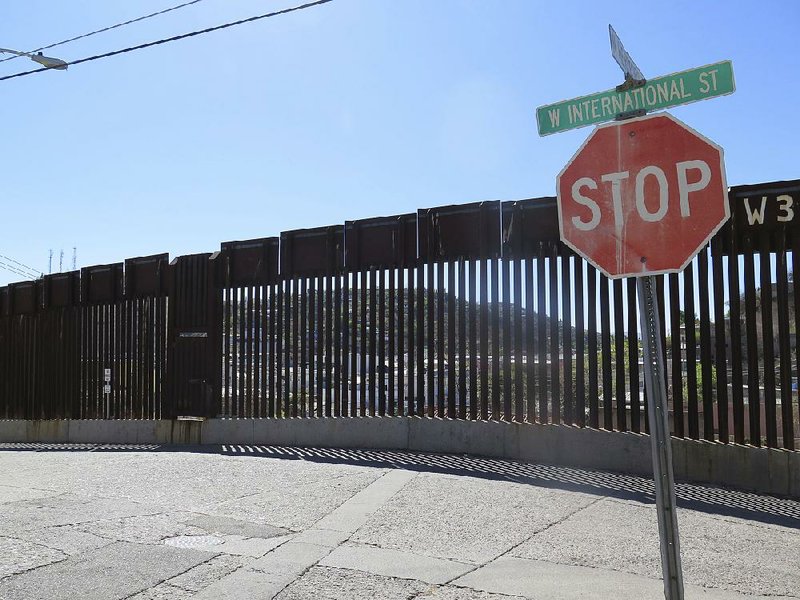 This 2016 file photo shows a section of the international border fence in Nogales, Ariz. Reports that a group of Middle Eastern men had been caught crossing the border illegally from Mexico into Arizona two years ago set off alarms among conservative bloggers and Arizona Gov. Doug Ducey.
