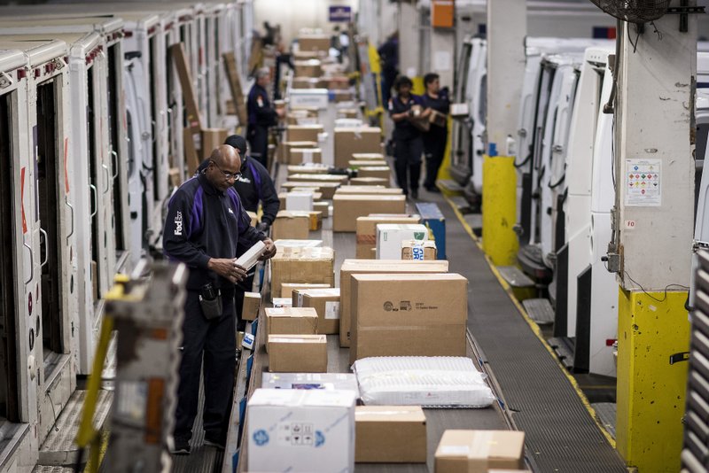 Employees sort packages for delivery at the FedEx Corp. shipping center in Chicago on Nov. 27, 2017. The holiday shopping season is off to a strong start and retailers appear to be continuing the momentum today -- Cyber Monday -- the biggest online spending day of the year. 