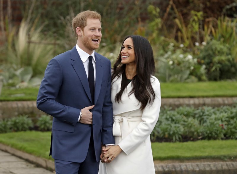 The Associated Press ROYAL ENGAGEMENT: Britain's Prince Harry and his fiancee Meghan Markle pose for photographers during a photocall in the grounds of Kensington Palace Monday in London. Britain's royal palace says Prince Harry and actress Meghan Markle are engaged and will marry in the spring of 2018.