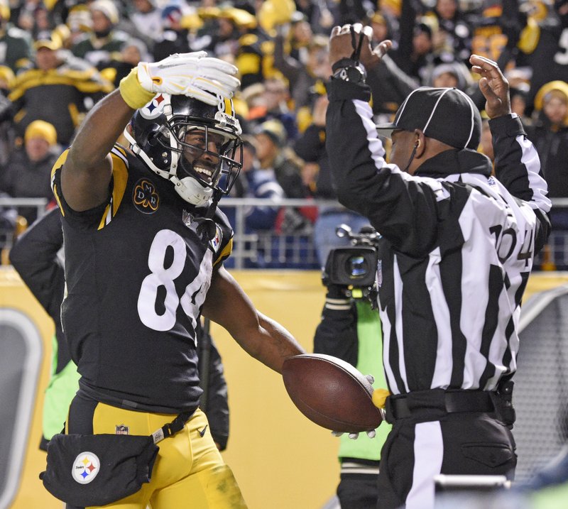 The Associated Press BROWN DELIVERS: Pittsburgh Steelers wide receiver Antonio Brown (84) celebrates his touchdown catch in front of field judge Dale Shaw (104) during the second half of an NFL game against the Green Bay Packers in Pittsburgh, Sunday.