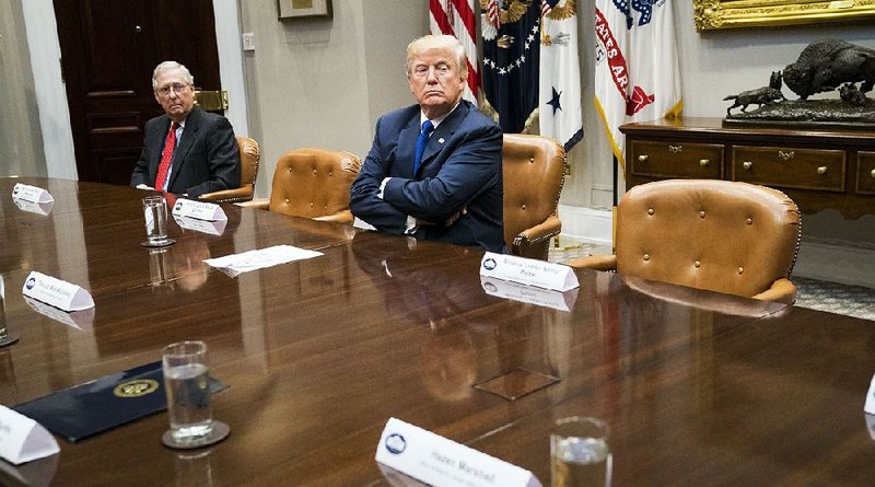 President Donald Trump sits in a White House meeting Tuesday beside empty seats that had been reserved for House Minority Leader Nancy Pelosi and Senate Minority Leader Charles Schumer. 