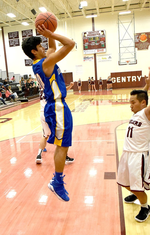 Photo by Mike Eckels With Auvan Vang (Gentry 11) firmly set on the inside of the lane, Decatur's Jimmy Mendoza puts up a jumper over Vang's block during the Gentry-Decatur senior boys' basketball contest at Pioneer Gym in Gentry Nov. 20.