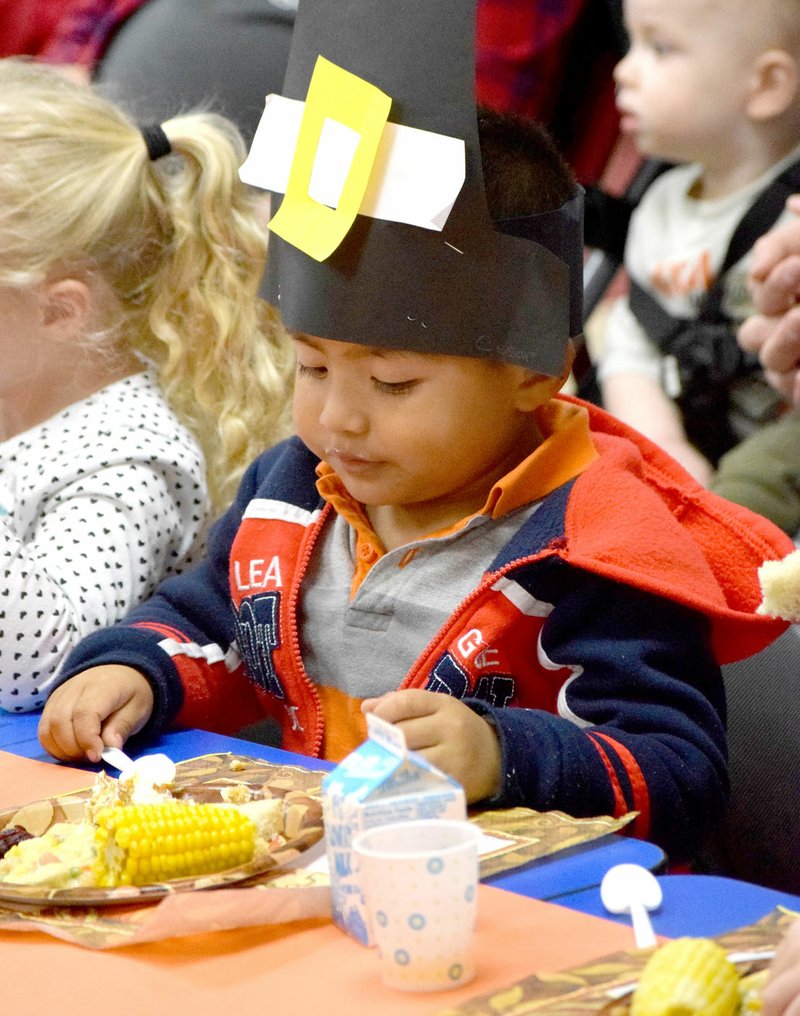 Photo by Mike Eckels Wearing a paper pilgrim buckle hat, Cesar Suarez chowed down on a traditional holiday feast during the Thanksgiving celebration in the classroom of Joyce Turnage at Decatur Pre-K School in Decatur Nov. 21.