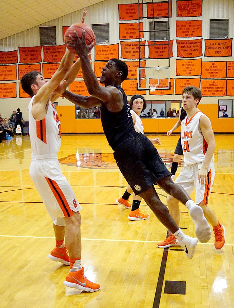 WESTSIDE EAGLE OBSERVER/Randy Moll Bentonville's Cadarius Baggett attempts to shoot over Chris Childress of Gravette during nonconference play between Bentonville and Gravette at the Lion Field House in Gravette on Tuesday, Nov. 21, 2017.