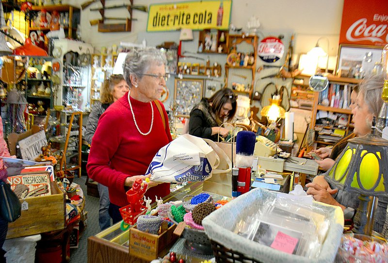 Janelle Jessen/Herald-Leader Customers lined up to make holiday purchases at 2 Gals Junk.