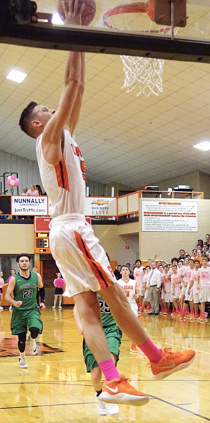 NWA DEMOCRAT-GAZETTE/Randy Moll Gravette senior Dayten Wishon breaks away from his Greenland defenders and dunks the ball during play at Gravette between the Lions and the Pirates on Tuesday, Nov. 28, 2017.