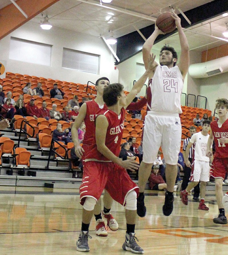The Sentinel-Record/Mandie Gober SENIOR EAGLE: Cutter Morning Star senior Jaylen Puckett shoots over Glen Rose defenders in Monday's 52-45 loss in the Magnet Cove senior basketball tournament. The loss was the first of the season for the Eagles.