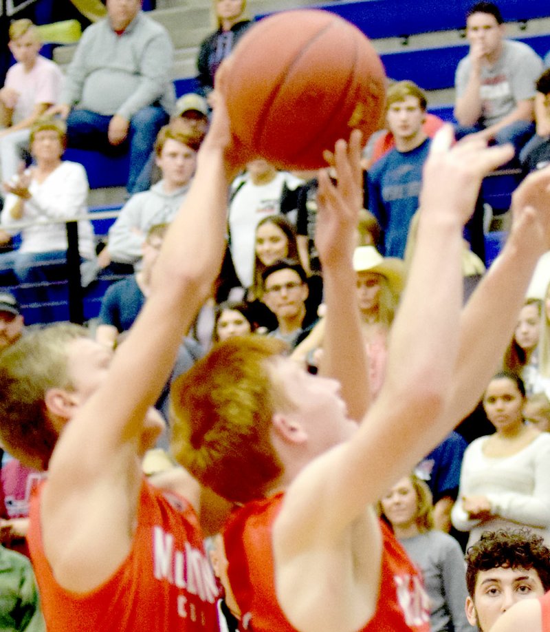 RICK PECK SPECIAL TO MCDONALD COUNTY McDonald County&#x2019;s Boston Dowd takes a rebound away from teammate Blake Gravette during the Mustangs&#x2019; 68-42 loss to Joplin on Monday night in the opening round of the 71st Carthage Invitational Boys Basketball Tournament at Carthage High School