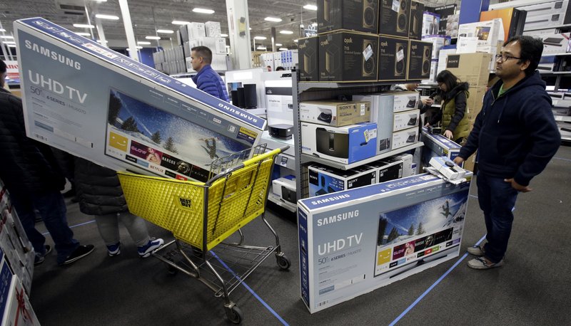 People wait to pay for televisions Nov. 23 as they shop a sale at a Best Buy store on Thanksgiving Day, in Overland Park, Kan. For the five-day period that ended the Monday after Thanksgiving, shoppers seemed to spend more in 2017 compared to a year earlier. (AP Photo/Charlie Riedel, File)