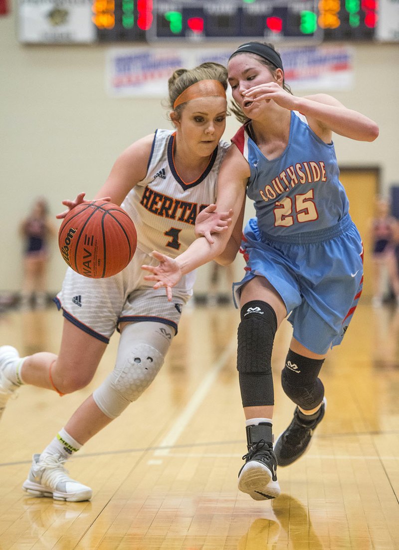 NWA Democrat-Gazette/BEN GOFF @NWABENGOFF Erin Graham (25) of Fort Smith Southside strips the ball from Faith Rohrbough (4) of Rogers Heritage on Thursday during the first round of the Great 8 Girls Basketball Classic at War Eagle Arena in Rogers.