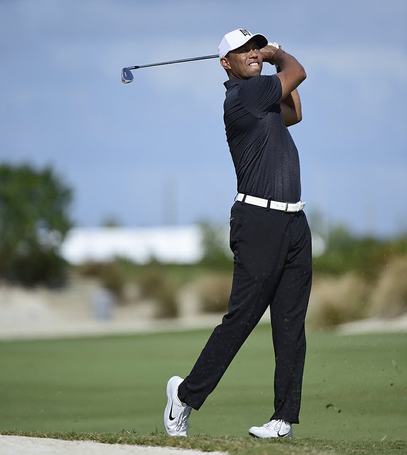 The Associated Press IN FINE FORM: Tiger Woods hits from the fourth fairway at the Hero World Challenge golf tournament at Albany Golf Club in Nassau, Bahamas, Thursday. The tournament is the first that Woods has participated in since withdrawing from the Dubai Desert Classic on Feb. 3 with back spasms.