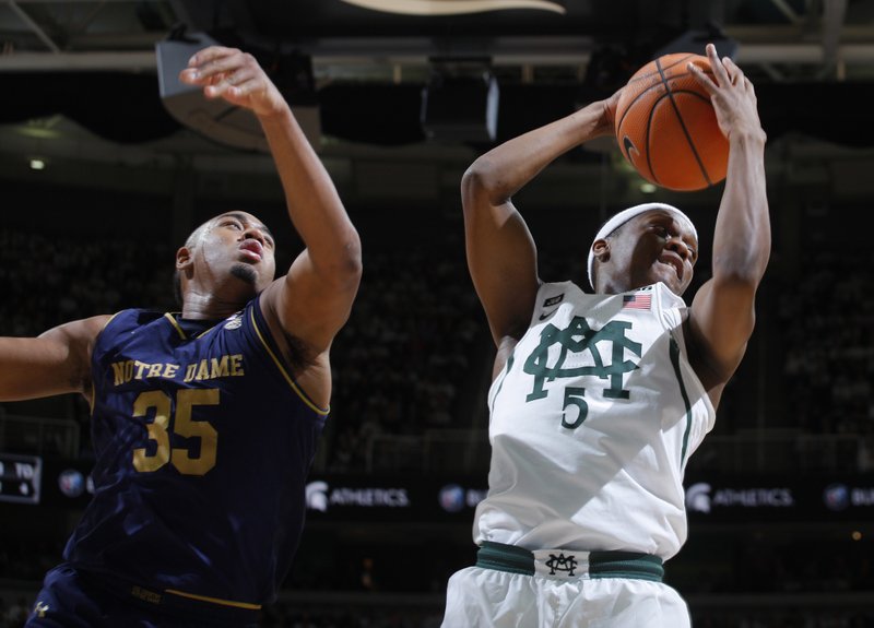 The Associated Press PULLING ONE DOWN: Michigan State's Cassius Winston, right, grabs a rebound against Notre Dame's Bonzie Colson (35) during the first half of an NCAA basketball game Thursday in East Lansing, Mich.