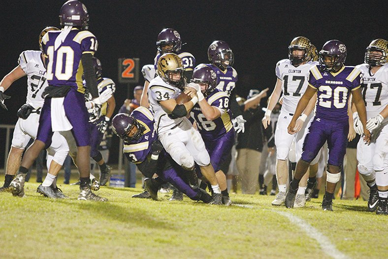 Terrance Armstard/News-Times Junction City's Jalen Davis (3) and Brock McGoogan (18) try to bring down Clinton's Sky Davidson (34) during their meeting in the 3A quarterfinals last week at David Carpenter Stadium. Tonight, Junction City hosts Osceola in the semifinals with a berth in next week's 3A state championship game on the line. Game time is 7 p.m.