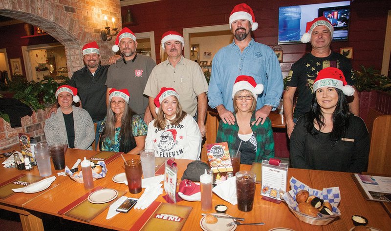 In the front row, from left, Stephanie Sheppard, Judy Hicks, Debbie Price, Sondra Bloesch and Lori Betts; and back row, Charlie Osborne, Pete Snowden, Greg Price, Kevin Bloesch and Dusty Betts meet up to plan Christmas 4 Kids. Price said the event will take place from 11 a.m. to 4 p.m. Saturday at 800 Truman Baker Drive in Searcy, and activities will include bounce houses, a motorcycle ride, monster truck rides, a power-wheels derby, an ATV stunt show, a bike show and a car show.