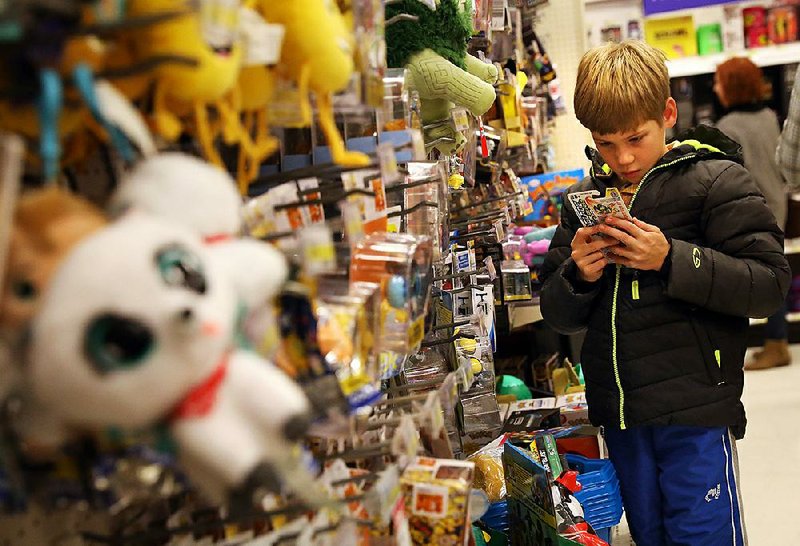 Aaron Mizerny, 9, shops in the toy section at Target in Ballwin, Mo., on Black Friday. Retailers had a good Thanksgiving weekend, but keeping customers coming into stores is a challenge as Christmas nears. 
