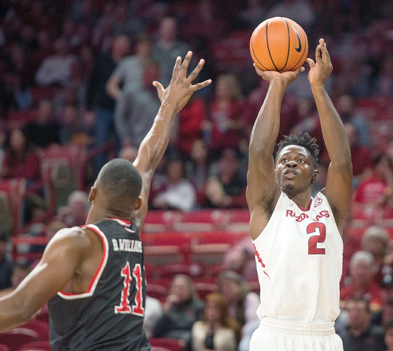 NWA Democrat-Gazette/Ben Goff SURPRISE DEFENDER: Adrio Bailey, Arkansas forward, shoots as Bryson Williams, Fresno State forward, defends in the first half Nov. 17 at Bud Walton Arena in Fayetteville. The 6-5 forward leads the Razorbacks with 13 blocks.