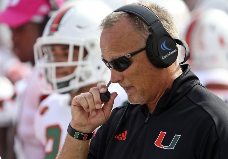 FILE- In this Saturday, Oct. 7, 2017, file photo, Miami's head coach Mark Richt talks into his headset during the first quarter of an NCAA college football game with Florida State in Tallahassee, Fla. Miami faces Clemson in the ACC championship on Saturday. 