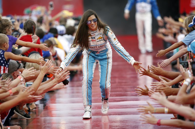 FILE - In this July 2, 2016, file photo, Danica Patrick greets fans during driver introductions before the start of the NASCAR Sprint Cup auto race at Daytona International Speedway in Daytona Beach, Fla. Patrick will race only 2 more times next season and end her career at the Indianapolis 500. It will end nearly 2 decades of racing for one of the most recognizable athletes in the world and send Patrick to a new phase of her life. (AP Photo/Wilfredo Lee, File)