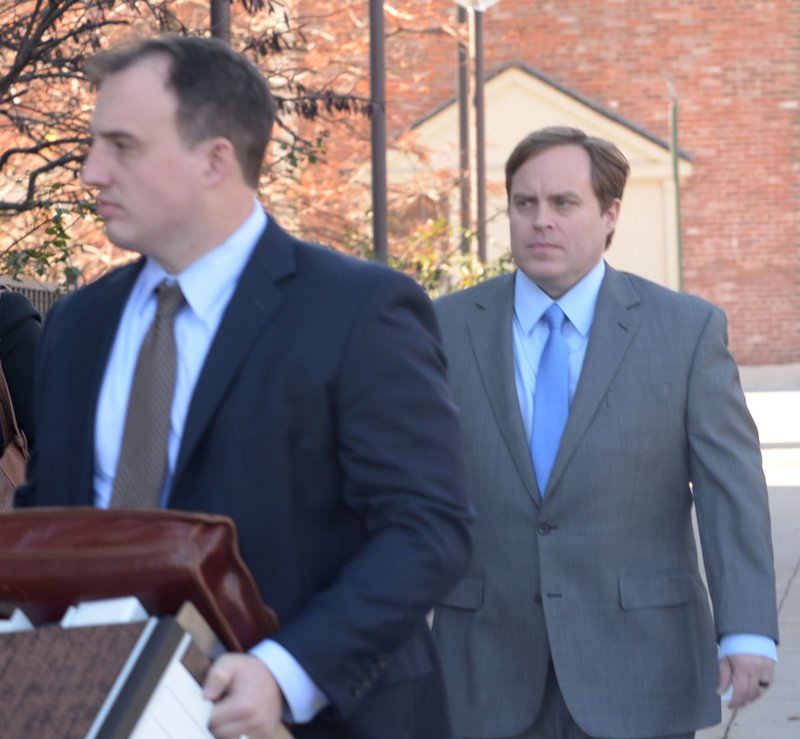 Former state Sen. Jon Woods (right), surrounded by members of his legal team, walks Thursday, Nov. 30, 2017, into the John Paul Hammerschmidt Federal Building in Fayetteville.
