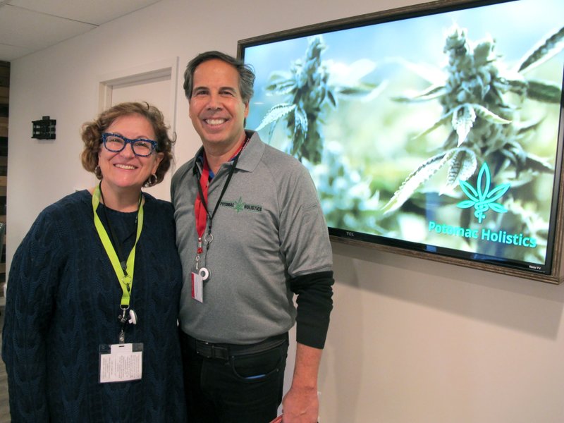 Louise Fisher and William Askinazi, who are co-owners of a medical marijuana dispensary called Potomac Holistics, stand in the store in Rockville, Md., on Friday, Dec. 1, 2017, hours before they were scheduled to receive their first shipment and begin selling medical marijuana, among the first dispensaries in the state to do so. (AP Photo/Brian Witte)