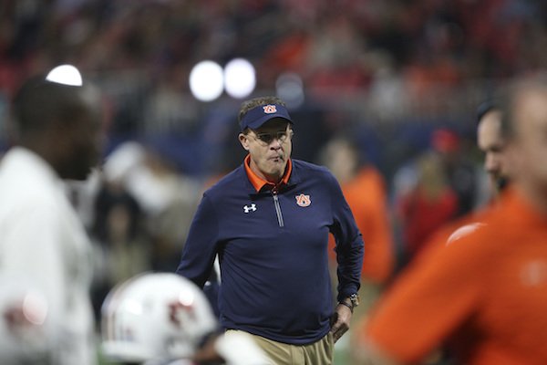 Auburn head coach Gus Malzahn watches teams warm up before the first half of the Southeastern Conference championship NCAA college football game between Auburn and Georgia, Saturday, Dec. 2, 2017, in Atlanta. (AP Photo/John Bazemore)
