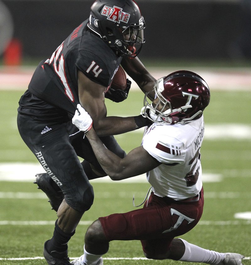 Troy cornerback Jawon McDowell (27) tackles Arkansas State wide receiver Chris Murray (14) during the second quarter of an NCAA college football game Saturday, Dec. 2, 2017, in Jonesboro, Ark. (Tommy Metthe/The Arkansas Democrat-Gazette via AP)

