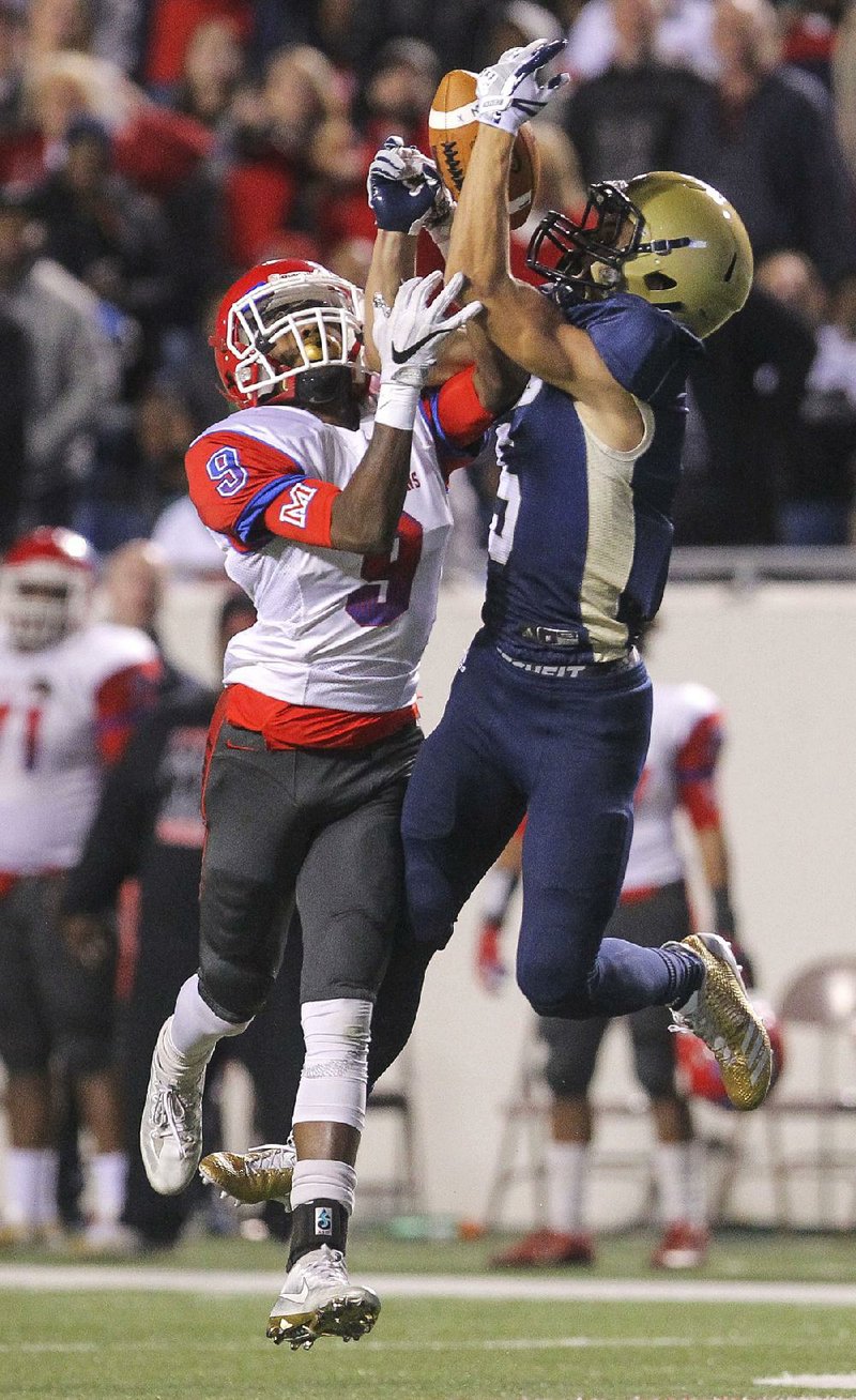 Pulaski Academy’s John David White (right) intercepts a pass in the end zone intended for Little Rock McClellan’s Jaylin Cunningham in the fourth quarter.