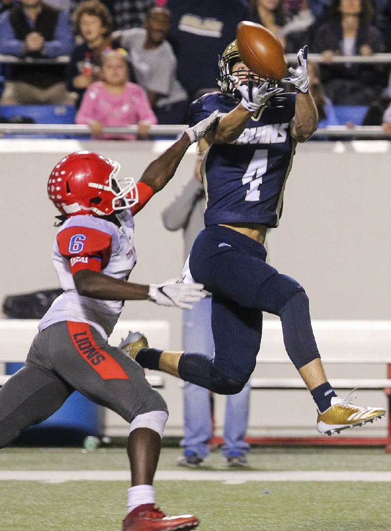 Pulaski Academy’s Brett Lynch (4) catches a 47-yard pass from Layne Hatcher in front of Andre Campbell on the go-ahead drive in the fourth quarter during the Bruins’ victory in the Class 5A championship game Saturday night at War Memorial Stadium in Little Rock.
