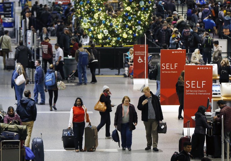 FILE - In this Wednesday, Nov. 22, 2017, file photo, passengers pass through Terminal A at Logan International Airport in Boston. It's getting late for booking holiday travel, but not too late. Experts say there are tips for procrastinators to find affordable airfares and hotel rooms. Flexibility is the key. (AP Photo/Michael Dwyer, File)