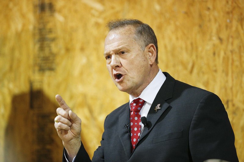 FILE - In this Thursday, Nov. 30, 2017 file photo, former Alabama Chief Justice and U.S. Senate candidate Roy Moore speaks at a campaign rally, in Dora, Ala. Federal fundraising reports released Friday, Dec. 1, reveal that Moore is losing the battle for campaign cash to Democrat Doug Jones. And he's losing badly. (AP Photo/Brynn Anderson, File)