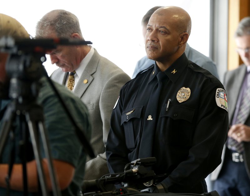 Charlottesville Police Chief Al S. Thomas Jr. listens to Attorney Timothy Heaphy as he delivers an independent report on the issues concerning the white supremacist rally and protest in Charlottesville, during a news conference in Charlottesville, Va., Friday, Dec. 1, 2017. (AP Photo/Steve Helber)