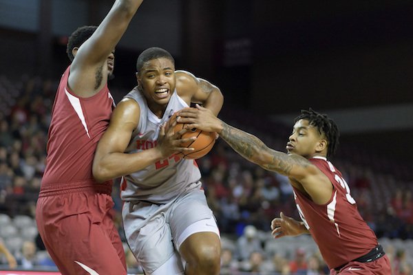 Arkansas' Anton Beard (31) attempts to grab the ball from Houston's Breaon Brady (24) during the first half of an NCAA college basketball game, Saturday, Dec. 2, 2017 in Houston. (Wilf Thorne/Houston Chronicle via AP)
