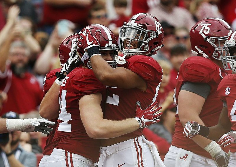 Alabama tight end Hale Hentges (left) celebrates with Irv Smith Jr. after scoring a touchdown earlier this season. The Crimson Tide was selected over Ohio State for the fi nal spot in the College Football Playoff and will play Clemson on Jan. 1 in the Sugar Bowl.
