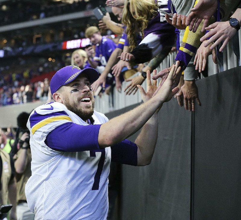 Minnesota quarterback Case Keenum celebrates with fans after the Vikings defeated the Atlanta Falcons 14-9 on Sunday in Atlanta. Keenum threw for 227 yards and two touchdowns in the victory.