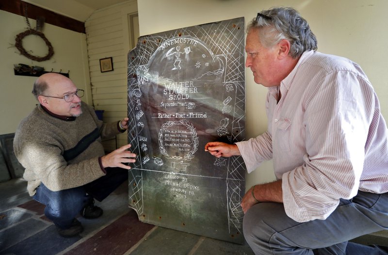 Walter Skold, left, and gravestone carver Michael Updike discuss the design of Skold's future tombstone, Friday, Dec. 1, 2017, in Newbury, Mass. Skold drew inspiration from his visits to the graves of more than 600 poets for his own tombstone to be carved by the son of novelist John Updike. The design represents a poignant and humorous mishmash inspired by the graves of poets including John Keats, Herman Melville, Elizabeth Frost and Frances Osgood. (AP Photo/Robert F. Bukaty)