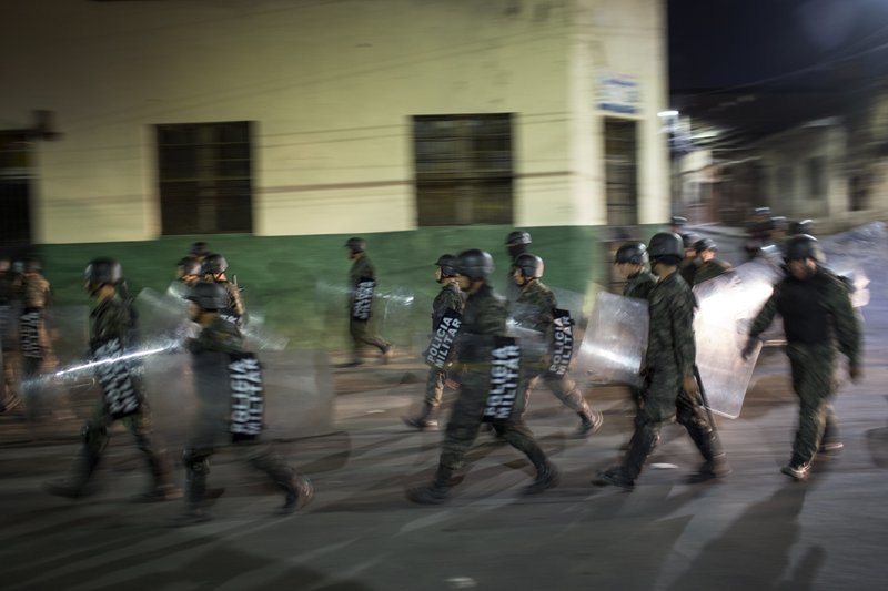 Military police patrols during government imposed dawn-to-dusk curfew in Tegucigalpa, Honduras, late Saturday, Dec. 2, 2017. The main opposition candidate called Saturday for Honduras' disputed presidential election to be held again after the country erupted in deadly protests over the delayed vote count. (AP Photo/Rodrigo Abd)