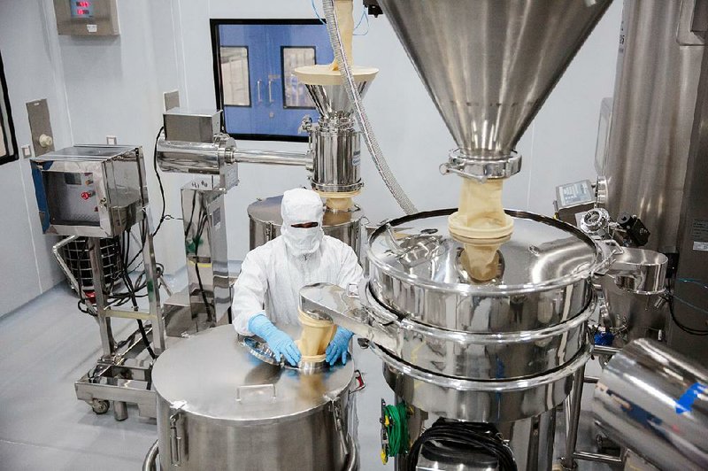 An employee operates a filtration machine inside a laboratory at a Laurus Labs Ltd. pharmaceutical plant in Visakhapatnam, Andhra Pradesh, India. The factory is preparing to churn out billions of generic pills for HIV patients.