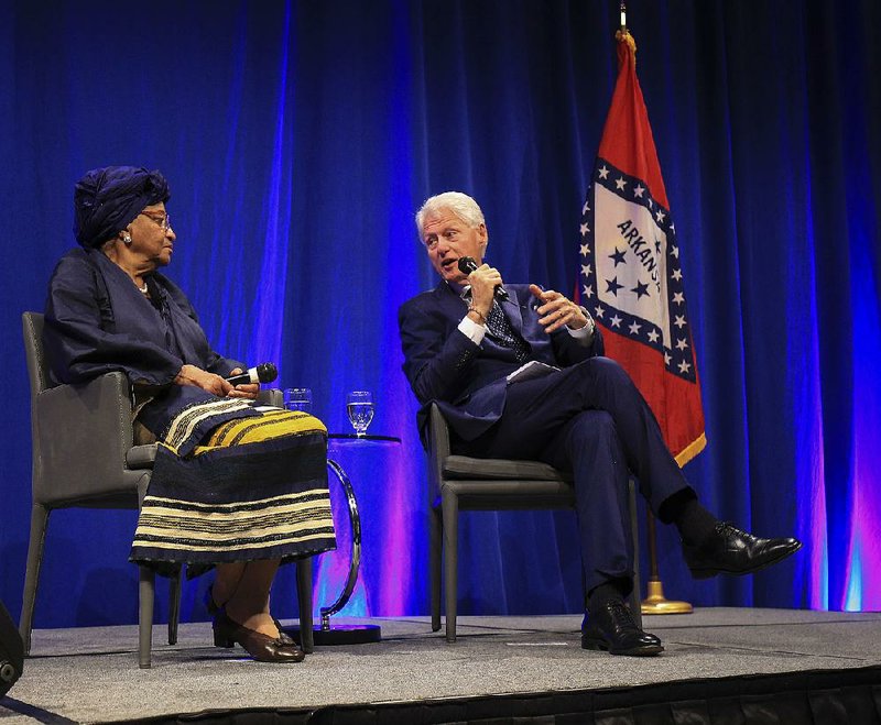 Former President Bill Clinton (right) talks with Liberian President Ellen Johnson Sirleaf on Monday night in Little Rock during “A Conversation with President Ellen Johnson Sirleaf and President Bill Clinton,” part of the Frank and Kula Kumpuris Distinguished Lecture Series.