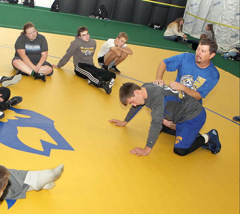 The Sentinel-Record/Richard Rasmussen DEMONSTRATING CONCEPTS: Lakeside High School wrestling coach H.E. Burchard, right runs a wrestling practice at the school during wrestling practice Friday.