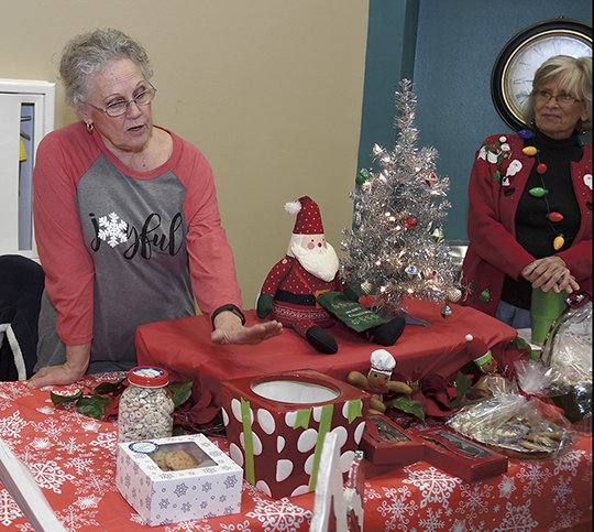 The Sentinel-Record/Mara Kuhn - Marilyn Hurst of Hot Springs sells baked goods at the Christmas Charity Bazaar at Hot Springs Baptist Church on Saturday, Dec. 2, 2017. The bizaar, which included several area vendors, raised funds for Recovery Point Ministry.