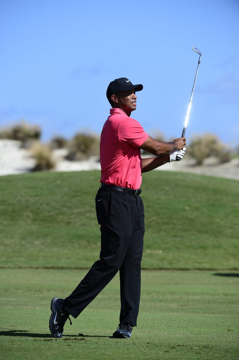 The Associated Press WOODS IS BACK: Tiger Woods shoots from the fairway of the third hole of the Hero World Challenge at Albany Golf Club in Nassau, Bahamas, Sunday.