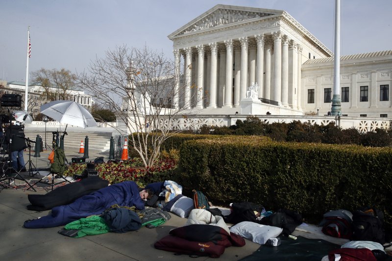People sleep outside of the Supreme Court in order to save places in line for Dec. 5 arguments in 'Masterpiece Cakeshop v. Colorado Civil Rights Commission,' Monday, Dec. 4, 2017, outside of the Supreme Court in Washington. (AP Photo/Jacquelyn Martin)
