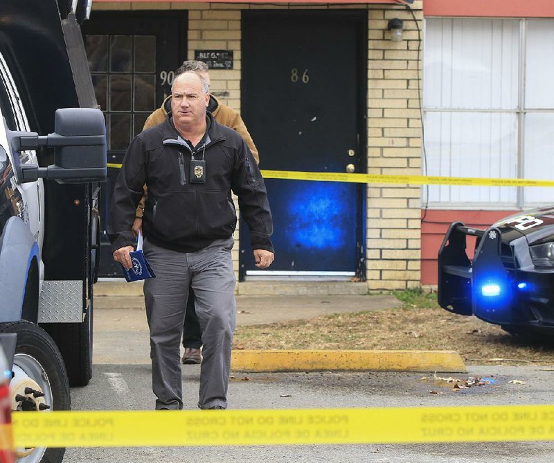 FILE — A Little Rock police detective leaves an apartment where the bodies of three people, including two young children, were found in the 6600 block of Lancaster Road. 