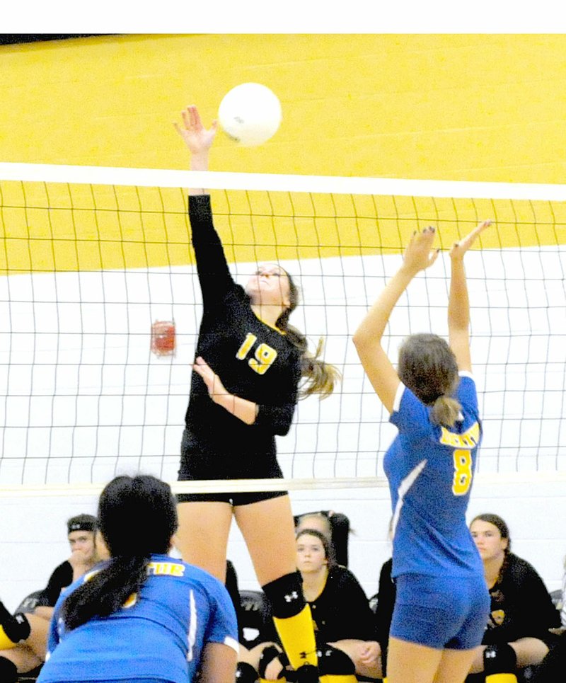 MARK HUMPHREY ENTERPRISE-LEADER Prairie Grove sophomore Emily Traylor attacks at the net against Decatur junior Talor Thompson. The Lady Tigers swept the Class 2A Lady Bulldogs, 25-16, 25-8, 26-17, on Oct. 10. Traylor was named All-Conference.